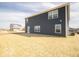 Exterior shot of the home showing the backyard and blue vinyl siding at 11322 N Quillow Way, Monrovia, IN 46157