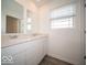 Bathroom featuring a double vanity with sleek white cabinets and modern fixtures at 11322 N Quillow Way, Monrovia, IN 46157