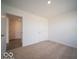 Bedroom with neutral carpet with an open doorway and a closet door at 11322 N Quillow Way, Monrovia, IN 46157
