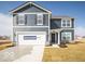 Charming two-story home features a blue facade, attached garage and inviting front entrance at 11322 N Quillow Way, Monrovia, IN 46157