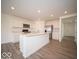 Modern kitchen boasts white cabinets, stainless steel appliances, and a large center island at 11322 N Quillow Way, Monrovia, IN 46157