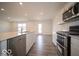 Bright kitchen featuring stainless appliances, including range and dishwasher, with spacious layout at 11322 N Quillow Way, Monrovia, IN 46157