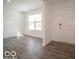 Bright, open living space features durable floors, a window, and neutral tones at 11322 N Quillow Way, Monrovia, IN 46157
