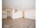 Open-concept living room with light wood floors and neutral walls offers a spacious and bright interior at 11322 N Quillow Way, Monrovia, IN 46157