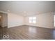 Bright and airy living area with durable flooring, ample space, and neutral wall colors at 11322 N Quillow Way, Monrovia, IN 46157
