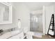 Bright bathroom features single vanity, marble countertop, shower, and toilet at 1339 S East St, Indianapolis, IN 46225