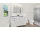 Bright bathroom features double vanity, marble countertop, shower, and toilet at 1339 S East St, Indianapolis, IN 46225