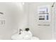 Bathroom featuring a single sink, toilet and a shower with subway tile at 1339 S East St, Indianapolis, IN 46225