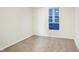 A bright bedroom with a window, neutral carpet, and white walls offers a blank canvas for your personal design at 1339 S East St, Indianapolis, IN 46225