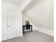 Bright bedroom with white walls, neutral carpet, and a small desk with chair, ready for personalized decor at 1339 S East St, Indianapolis, IN 46225