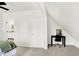Bright bedroom with white walls, neutral carpet, desk with office chair and an ensuite bathroom featuring a white vanity at 1339 S East St, Indianapolis, IN 46225