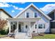 Charming two-story home featuring light gray siding, a welcoming front porch, and a well-maintained yard at 1339 S East St, Indianapolis, IN 46225