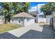 A detached garage with a gray stone facade and new roof tiles at 1339 S East St, Indianapolis, IN 46225