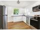 Bright kitchen offers white cabinets, stainless appliances, and wood-look floors at 1339 S East St, Indianapolis, IN 46225