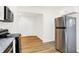 Bright kitchen features stainless refrigerator and stove appliances and ample cabinet space at 1339 S East St, Indianapolis, IN 46225