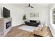 Bright living room with hardwood floors, modern fireplace, contemporary furniture, and stylish decor at 1339 S East St, Indianapolis, IN 46225