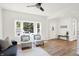 Bright living room with hardwood floors, large windows, modern furniture, and a ceiling fan at 1339 S East St, Indianapolis, IN 46225