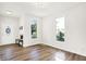 Bright living room with hardwood floors, large windows, and a modern, minimalist design aesthetic at 1339 S East St, Indianapolis, IN 46225