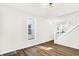 Open living room with wood-look floors, white walls, and white staircase at 1339 S East St, Indianapolis, IN 46225