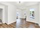 Bright living room features wood-look floors, white walls, and natural light from the windows at 1339 S East St, Indianapolis, IN 46225