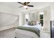 Inviting primary bedroom featuring neutral decor, a ceiling fan, and bright windows with decorative curtains at 1339 S East St, Indianapolis, IN 46225