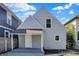 Cozy two-story home featuring vinyl siding, a gravel driveway, and a covered porch at 1339 S East St, Indianapolis, IN 46225