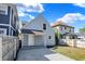 Light gray house with a gravel driveway, small porch, and privacy fence at 1339 S East St, Indianapolis, IN 46225