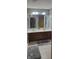 Bathroom featuring double sink vanity with tile backsplash and spacious mirror at 193 Sugarwood Ln, Avon, IN 46123