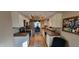 Kitchen featuring white cabinetry, stainless steel appliances, and a breakfast bar overlooking dining area at 193 Sugarwood Ln, Avon, IN 46123