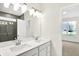 Bathroom featuring a double vanity, modern lighting, and access to a tiled shower and bedroom at 19726 Highclere Ln, Sheridan, IN 46069