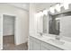 Bathroom featuring a double vanity, modern lighting, and access to a tiled shower and walk-in closet at 19726 Highclere Ln, Sheridan, IN 46069