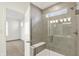 Modern bathroom with tiled shower, glass door, and a built-in seat, offering a spa-like experience at 19726 Highclere Ln, Sheridan, IN 46069