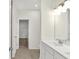 Bathroom featuring a double vanity, modern lighting, and access to a walk-in closet at 19726 Highclere Ln, Sheridan, IN 46069