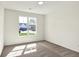 This bright bedroom features a window overlooking the front yard and tan carpet at 19726 Highclere Ln, Sheridan, IN 46069