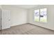 A cozy bedroom features tan carpet, a double hung window and a white door at 19726 Highclere Ln, Sheridan, IN 46069
