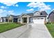 Attractive single-story home with a concrete driveway and landscaped front yard at 19726 Highclere Ln, Sheridan, IN 46069