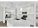 Modern kitchen featuring stainless steel appliances, white cabinets, and a spacious quartz island at 19726 Highclere Ln, Sheridan, IN 46069