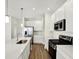 Modern kitchen featuring stainless steel appliances, white cabinets, and a spacious quartz island at 19726 Highclere Ln, Sheridan, IN 46069