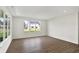 Bright living room with large windows and wood flooring, creating a welcoming and modern space at 19726 Highclere Ln, Sheridan, IN 46069
