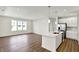 Open-concept living space with a kitchen island and bright natural light from large windows at 19726 Highclere Ln, Sheridan, IN 46069