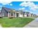 A street view of single Gathering homes with green lawns and freshly planted trees at 19726 Highclere Ln, Sheridan, IN 46069