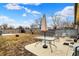 Backyard featuring a table with umbrella, shed, and bare foliage at 2709 Jackson St, Indianapolis, IN 46222