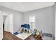 A large bedroom with a hardwood floor and some toys around the room at 2709 Jackson St, Indianapolis, IN 46222