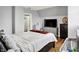 Neutral bedroom featuring hardwood floors, flatscreen television, and a bathroom adjacent to the bedroom at 2709 Jackson St, Indianapolis, IN 46222