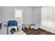 Bedroom room with hardwood floors and play furniture by the window and sliding glass door at 2709 Jackson St, Indianapolis, IN 46222