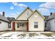 Charming yellow two-story home with brick-lined porch and front yard landscaping at 2709 Jackson St, Indianapolis, IN 46222