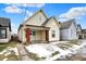 Charming yellow two-story home with brick-lined porch and front yard landscaping at 2709 Jackson St, Indianapolis, IN 46222