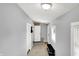 Bright hallway with neutral walls, tiled flooring, coat rack, and storage bench upon entry to the house at 2709 Jackson St, Indianapolis, IN 46222