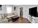 Comfortable living room featuring a gray sofa, modern decor, and hardwood floors at 2709 Jackson St, Indianapolis, IN 46222