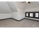 Attic bedroom features carpet, white walls, and black trim, with dormer windows at 2828 N Illinois St, Indianapolis, IN 46208